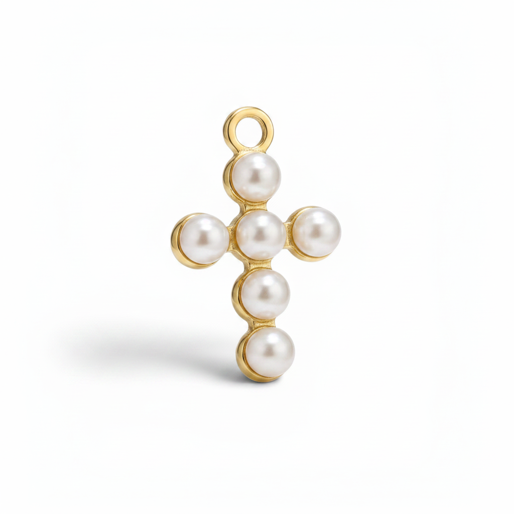 Gold cross pendant with pearls on a white background