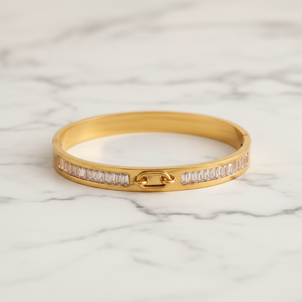 A gold bangle bracelet with rows of clear pavé-set stones on both sides and a central gold clasp, shown on a white background within a Shopify product listing interface.