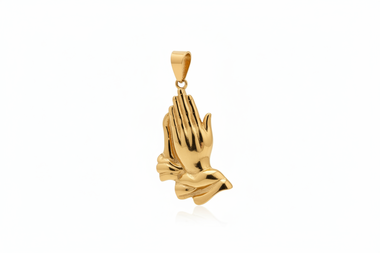 A polished yellow gold pendant shaped like praying hands, shown against a plain white background.