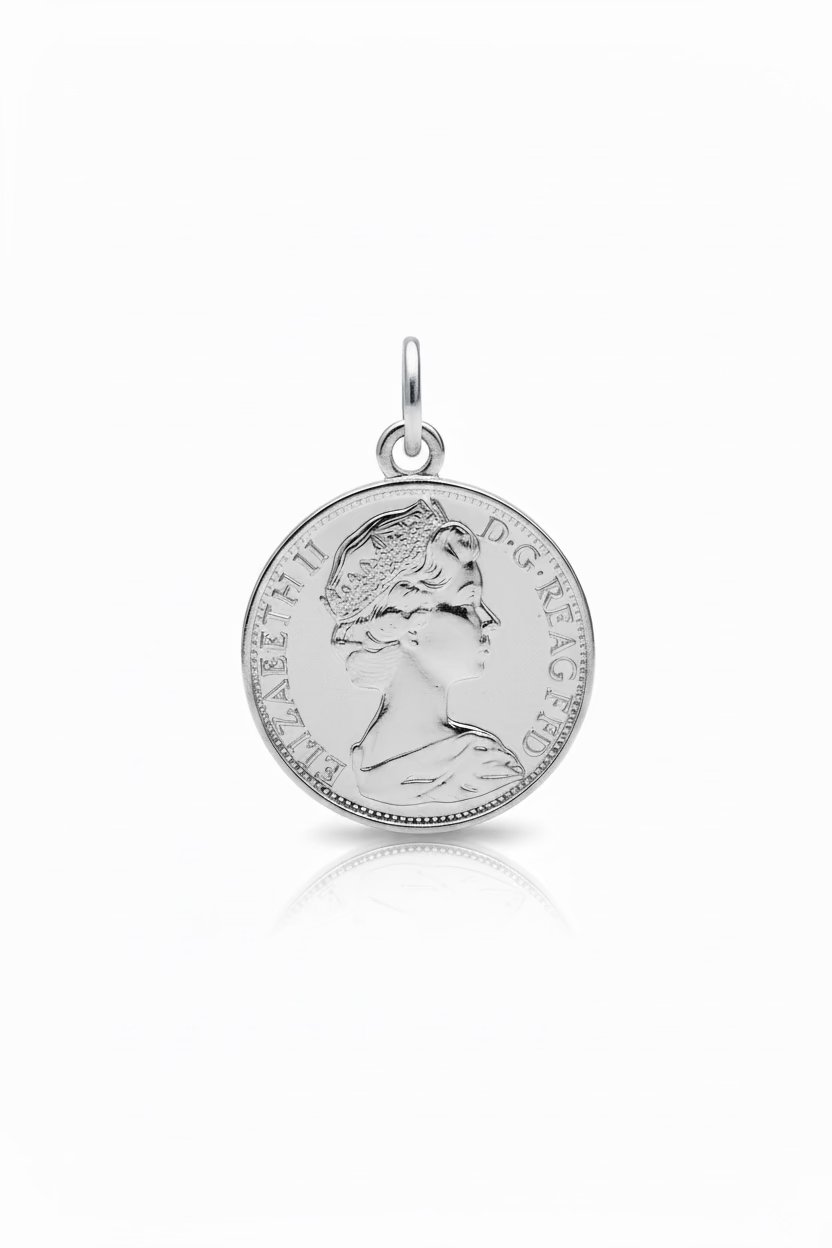 A hand holds a small jewelry box containing a silver-toned coin pendant necklace on a white chain. The box is labeled 'Coin type 2' and is photographed in a store setting with display cases in the background.